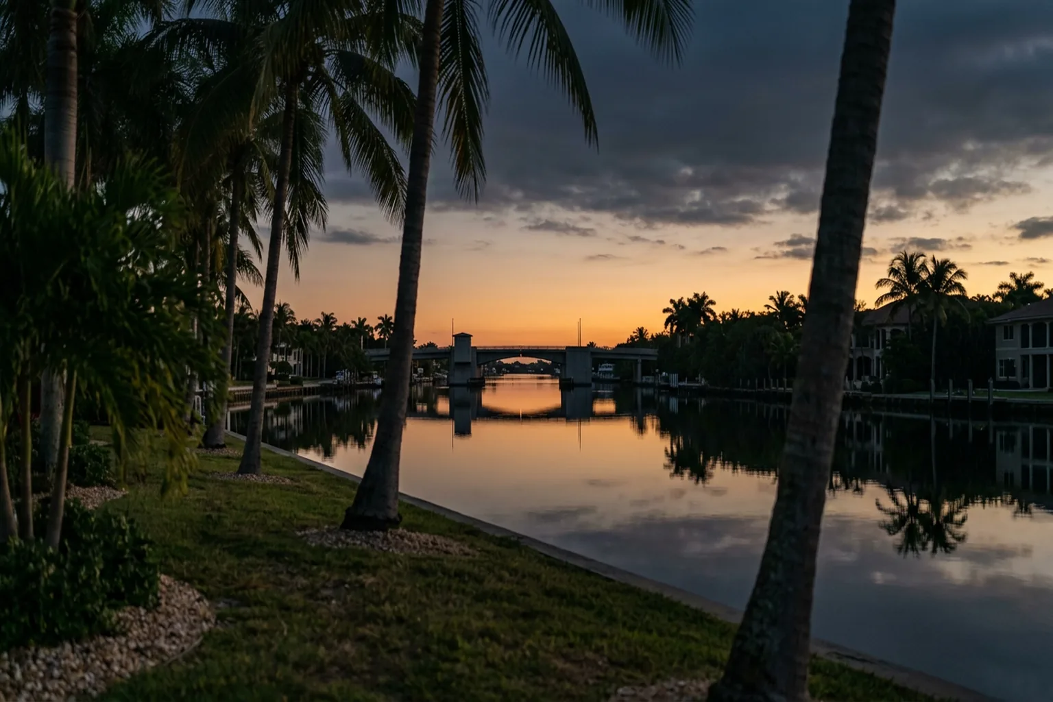 The Fort Lauderdale intracoastal waterway at sunrise, palms along a quiet residential bank